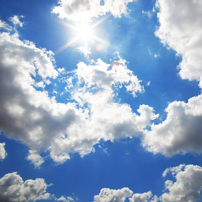 Blue sky with shinning sun and white clouds background