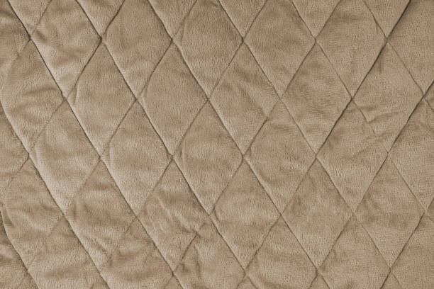 istock Quilted gray velours fabric background, wrinkled soft blanket surface 1626259511