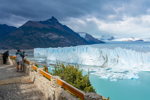 Santa Cruz, Argentina - February 4, 2023: Tourists observing the glacier on the boardwalks in the Perito Moreno Glacier of Los Glaciares National Park in Argentina.
