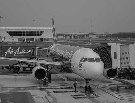 Kuala Lumpur, Malaysia - Dec 16, 2015. An AirAsia aircraft with gangway at the KLIA Airport in Kuala Lumpur, Malaysia. AirAsia is the largest airline in Malaysia by fleet size and destinations.