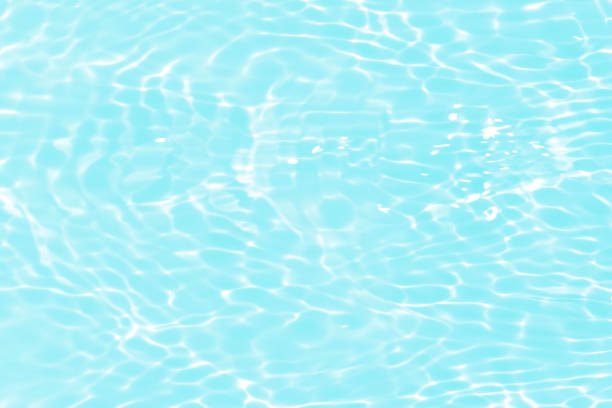 istock Blue water with ripples on the surface. Defocus blurred transparent blue colored clear calm water surface texture with splashes and bubbles. Water waves with shining pattern texture background. 1626446024