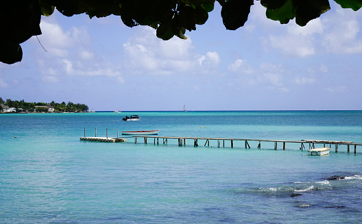 Small jetty with a wooden bridge in Mauritius. Mauritius is an island nation about 2,000 kilometres off the southeast coast of the African continent.