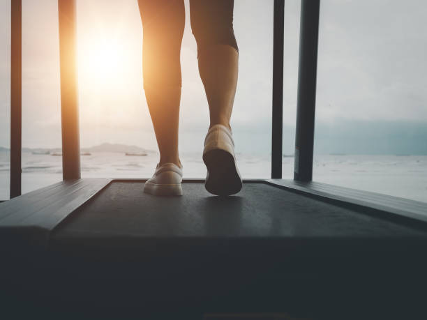 istock jogging on a treadmill In the evening when the sun shines through 1626499669
