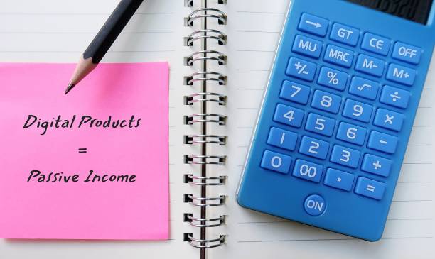 istock Calculator pencil on pink note with handwritten text DIGITAL PRODUCTS , PASSIVE INCOME - concept of creating profitable digital download or printable products with skills expertise to sell online and earn passive extra income 1626501272