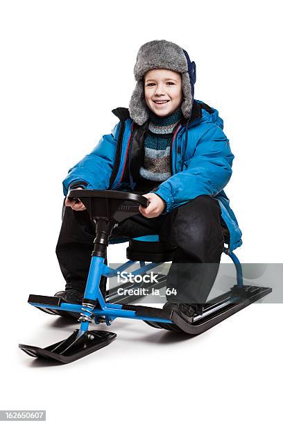 Niño En La Nieve Scooter O Snowmobile Juguete Foto de stock y más banco de imágenes de Motonieve - Motonieve, Actividad, Alegre