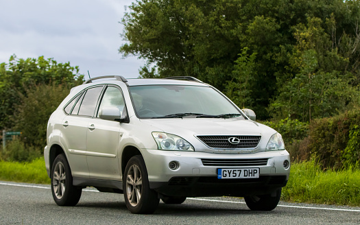 Woburn, Beds, UK - Aug 19th 2023: 2007 silver Lexus RX450H electric  car travelling on an English country road.