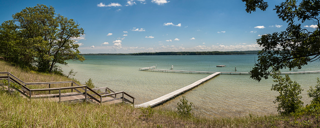 Summer scene beside a lake and pier at Interlochen, Michigan