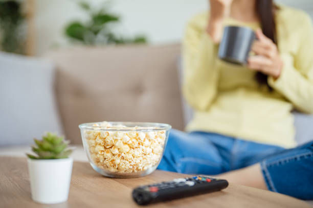 istock Asian woman Watching smart TV and using remote controller Hand holding television audio remote control at home with the remote control television 1626611961