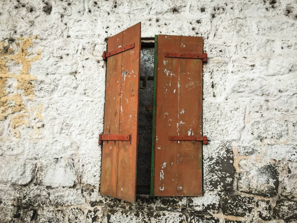 Old wooden window with dirty wall at ancient palace. Close up.