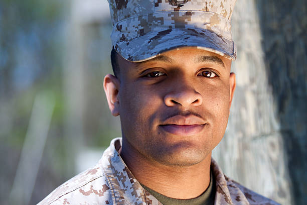 African American Marine African American Marine with a warm tone to the image. This was shot with a gold reflector to his right. black military man stock pictures, royalty-free photos & images