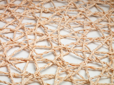 Straw knit underlayment. Straw knit underlayment. Close-up. Studio shoot. Handcrafted. Special pattern. There are no people.