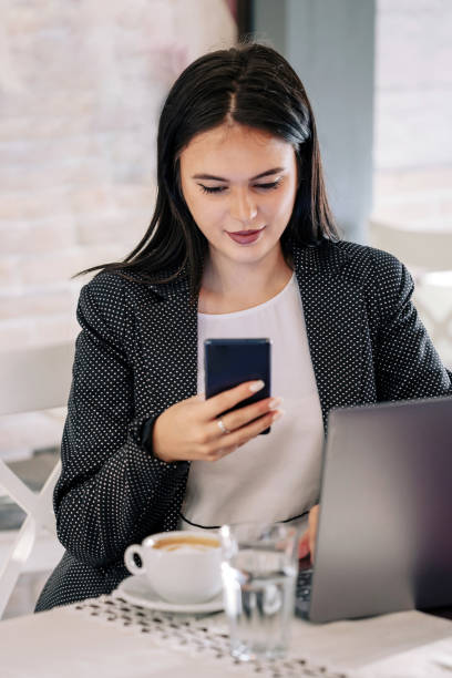 istock Young female freelancer talking on the phone in the cafe 1626642110