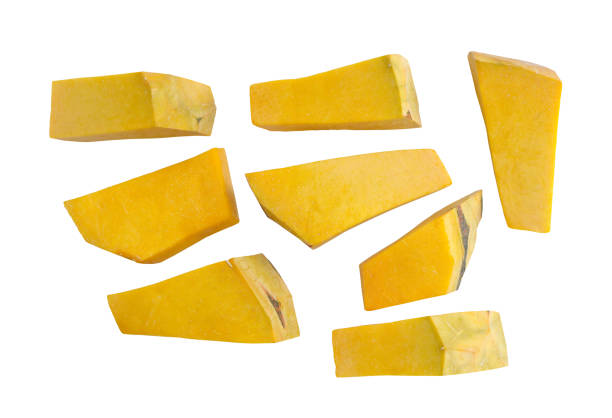 Set of multiple different piece of pumpkin on a white background with clipping path. Fresh pumpkin cut into small pieces, Top view