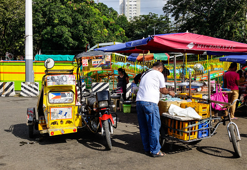 Manila, Philippines - Dec 21, 2015. Vendors sell food at street market in Manila, Philippines. Manila is regarded as one of the best shopping destinations in Asia.