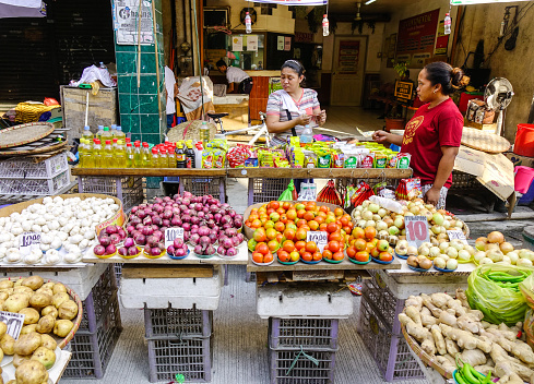 Manila, Philippines - Apr 12, 2017. Selling vegetables at market in Manila, Philippines. Manila is the center of culture, economy, education and government of the Philippines.