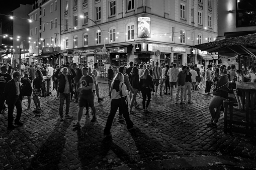 Hamburg, Germany - June 16 2023: Hans Albers Platz Square in the Red Light District and Party Area Kiez of St. Pauli on a Weekend Night in Black and White.