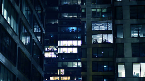 istock Pattern of office buildings windows illuminated at night. 1626688899