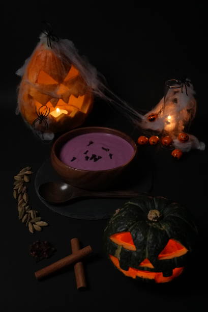 istock Halloween ominous soup and glowing jack-o-lanterns 1626691080