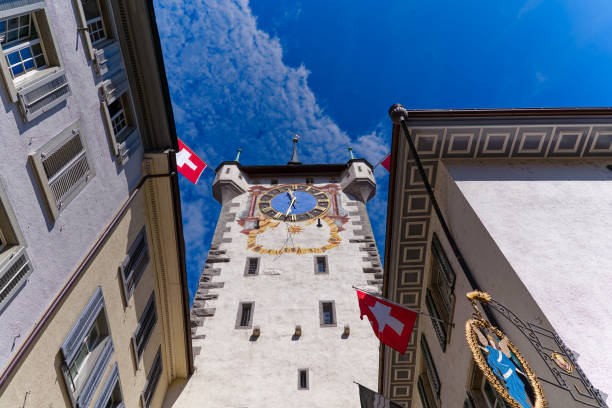 istock Scenic view of historic clock tower decorated with flags. 1626700253