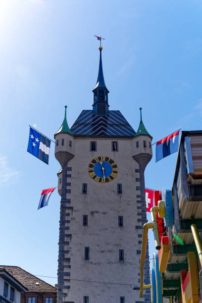 Scenic view of historic clock tower decorated with flags.