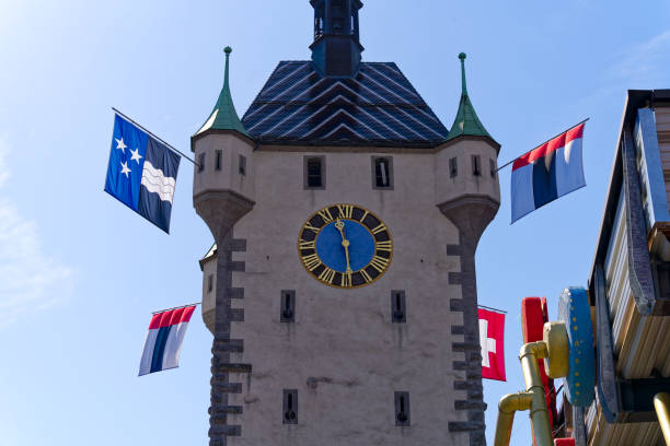 istock Scenic view of historic clock tower decorated with flags. 1626700263