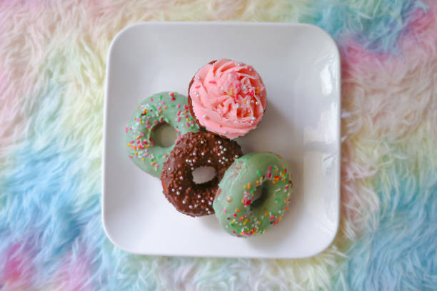 Assorted Cute Donuts on the white plate with colorful background