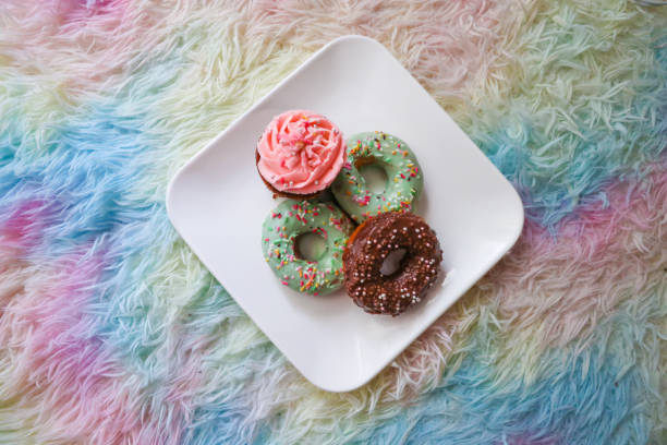 Assorted Cute Donuts on the white plate with colorful background