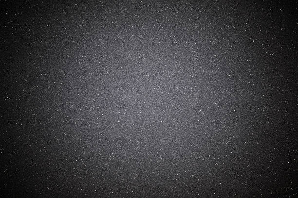 Black sand texture background with spotlight Overhead shot of a black sand texture background with spotlight. iron metal stock pictures, royalty-free photos & images