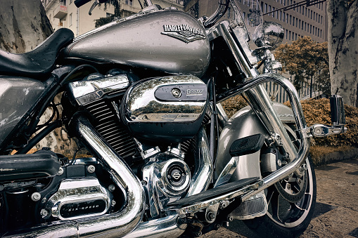 Close-up of a legendary Harley-Davidson motorcycle engine with frame and exhaust system tuning on a city street: Tbilisi, Georgia - June 22, 2023.