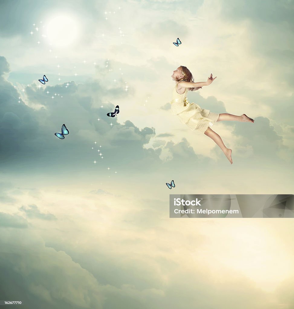 Little Girl Flying at Twilight Little Blonde Girl Flying with Butterflies at Twilight Child Stock Photo