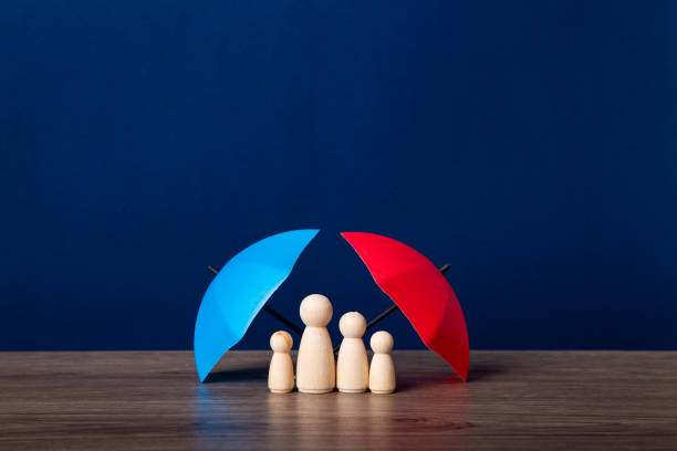 istock Umbrella and wooden doll figures. 1626795834