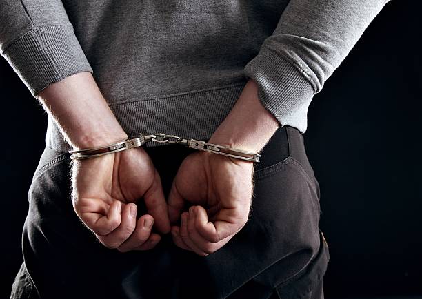 istock Outlaw's Hands Locked in Handcuffs 162681538