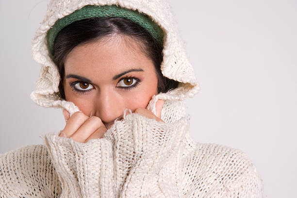 istock Seductive Attractive Woman Covering Half Her Face with Sweater 162682091