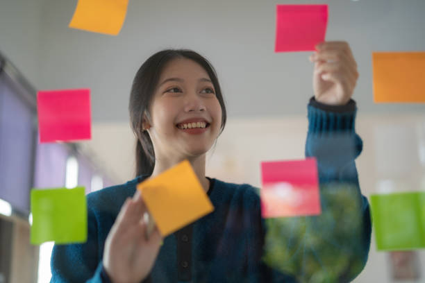 istock Young confident Businesswoman planning with adhesive notes in creative office. 1626826946