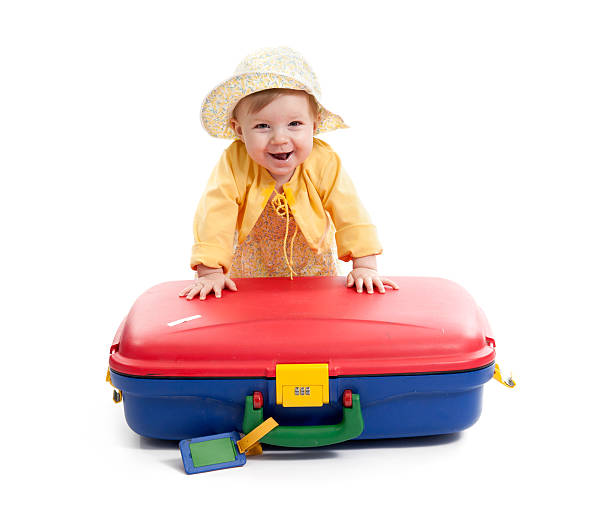 istock laughing baby with red and blue suitcase, on white 162682936