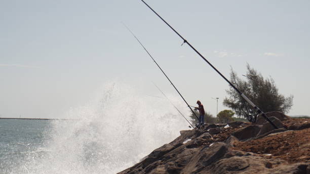 Fisherman and Wave stock photo