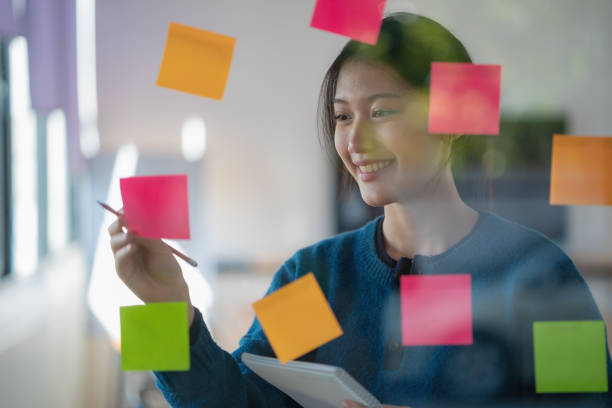 istock Young confident Businesswoman planning with adhesive notes in creative office. 1626836560