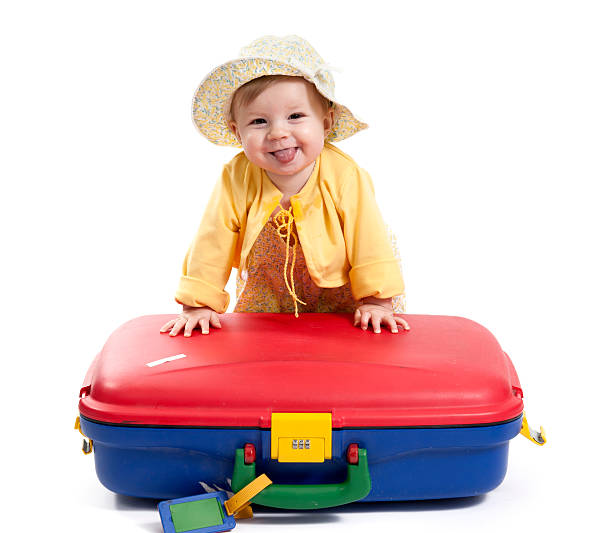 istock laughing baby with red and blue suitcase, on white 162684581