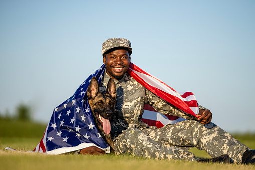 Heroes of the United States of America. Soldier and military dog covered with US flag.
