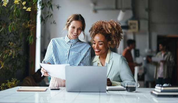 istock Two Happy Blonde Businesswomen Working In The Office Using Their Computer 1626848397