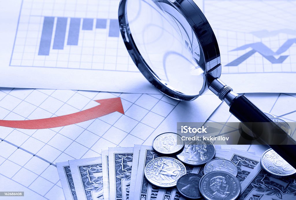 Business Chart Business concept. Magnifying glass and money on paper background with chart Analyzing Stock Photo