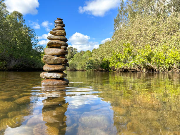 istock Rock stack built in the Nerang River.  Can see rocks under water.  Trees either side.  Blue skies in the distance.  Gold Coast Queensland Australia 1626870546