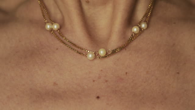 Closeup of a woman wearing pearl necklace