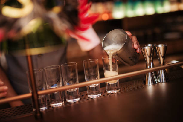 istock Bartender Pouring Cocktail Drink From Shaker to Shot Glass 1626883941