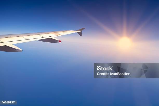 Flying Over The Sea At Sunset Stock Photo - Download Image Now - Aerial View, Aircraft Wing, Airplane