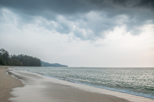 picturesque scenery at the coast of the sea in evening time, There are rain clouds in the sky, Phuket, Thailand,