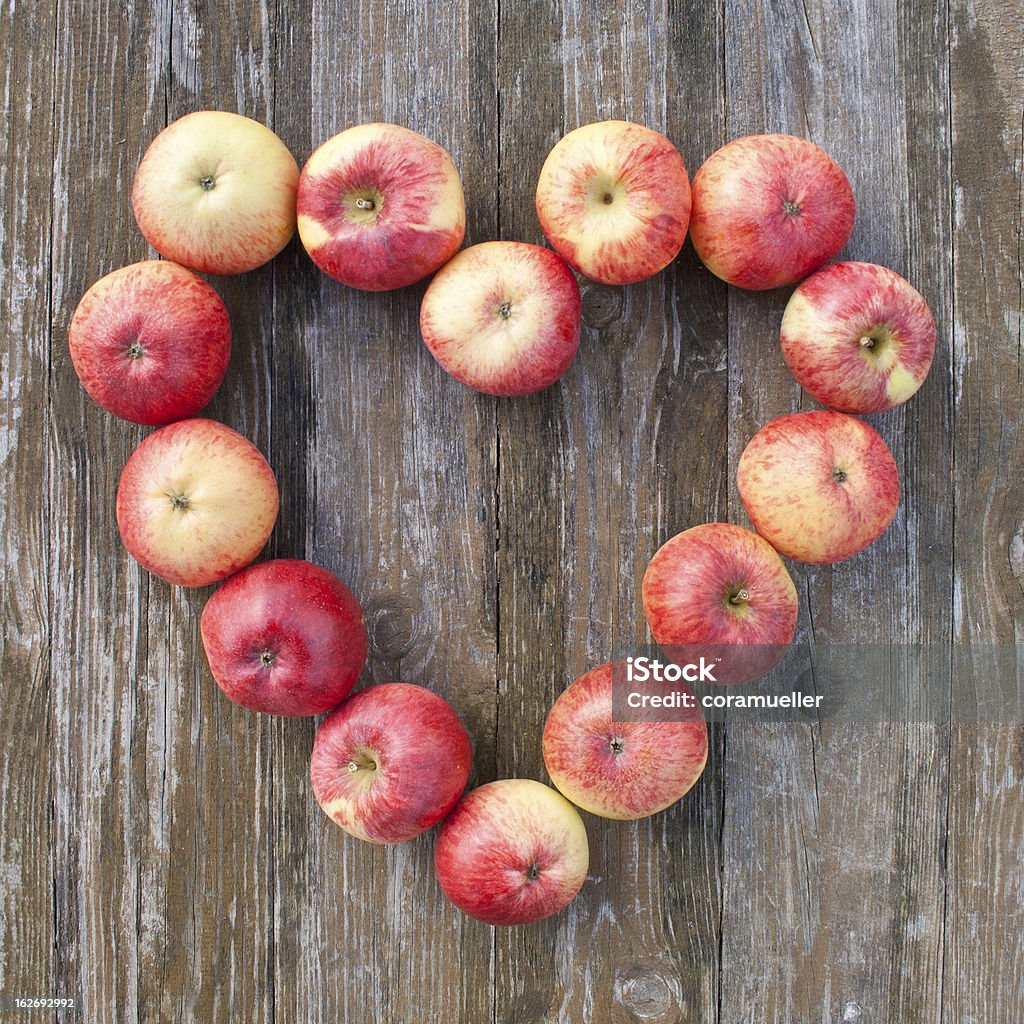 apples heart with apples on wooden ground Apple - Fruit Stock Photo