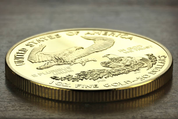 1 ounce American gold eagle bullion coin 1 ounce American gold eagle bullion coin on wooden background dollar bill eagle stock pictures, royalty-free photos & images