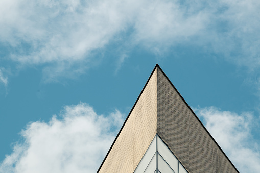 A corner of the building juts into the blue sky