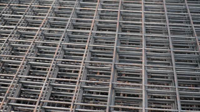 Slow motion video. Steel Rebars for reinforced concrete. steel wire mesh for concrete slab reinforcement of construction. Background and banner